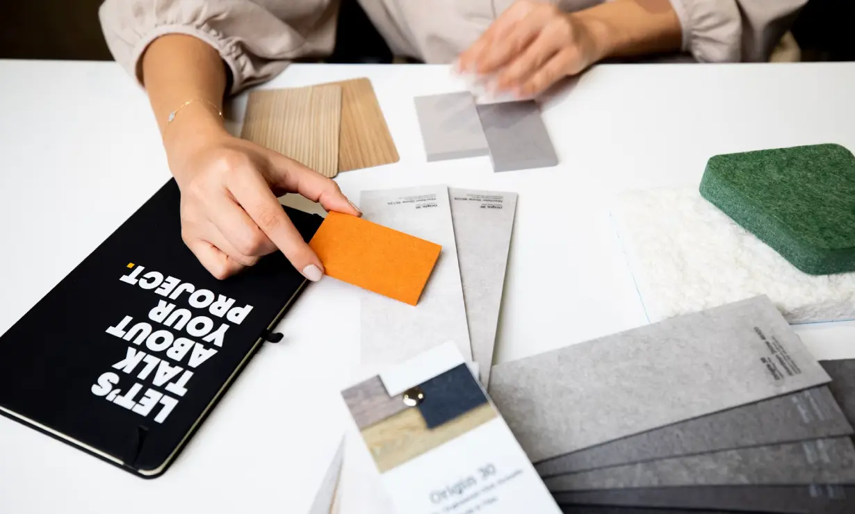 Interior designer reviewing mood boards in a design studio