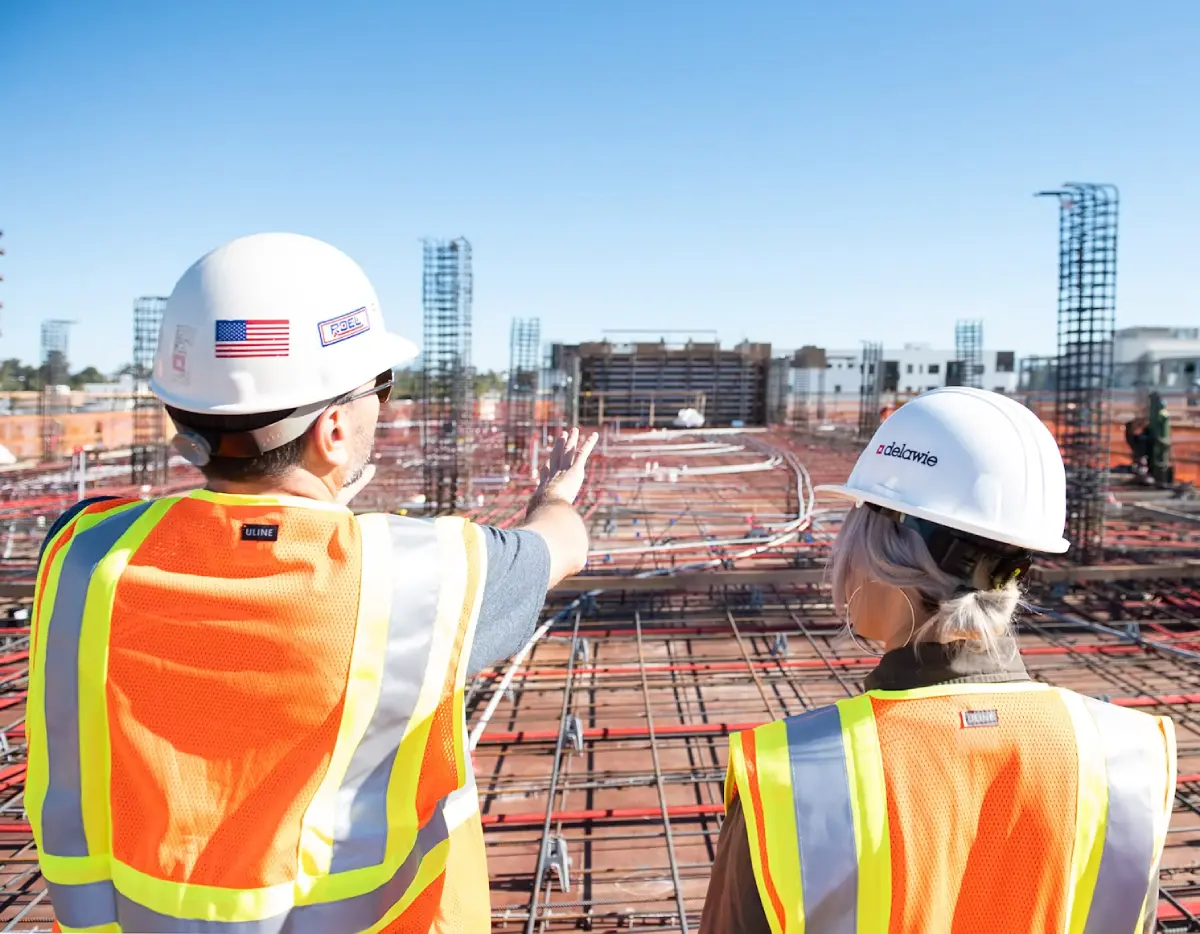 Construction project manager using a tablet to review AI takeoff data on site