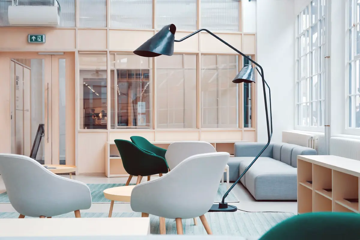 Interior designer comparing an AI-restyled room redesign on a laptop